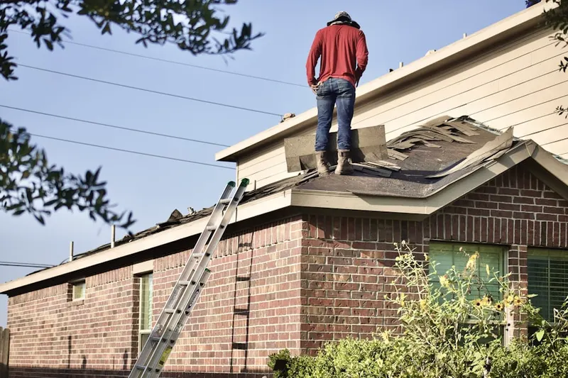 Professional roofer working on a residential roof in Siler City